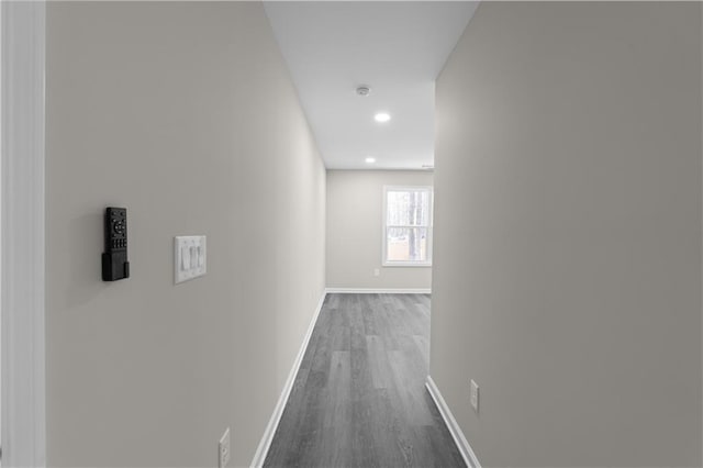 hallway with recessed lighting, dark wood finished floors, and baseboards