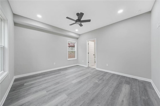 empty room with recessed lighting, ceiling fan, baseboards, and wood finished floors