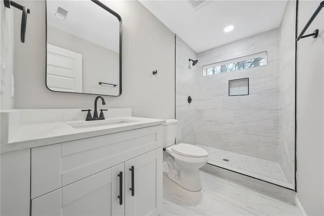 full bath featuring visible vents, toilet, marble finish floor, a tile shower, and vanity