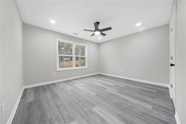 unfurnished room featuring recessed lighting, visible vents, a ceiling fan, wood finished floors, and baseboards