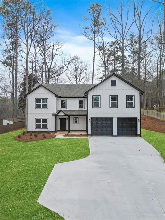 view of front of home featuring concrete driveway, a front lawn, roof with shingles, and an attached garage