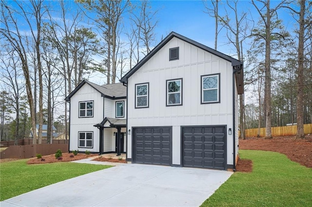 modern farmhouse style home featuring concrete driveway, board and batten siding, a front yard, and fence