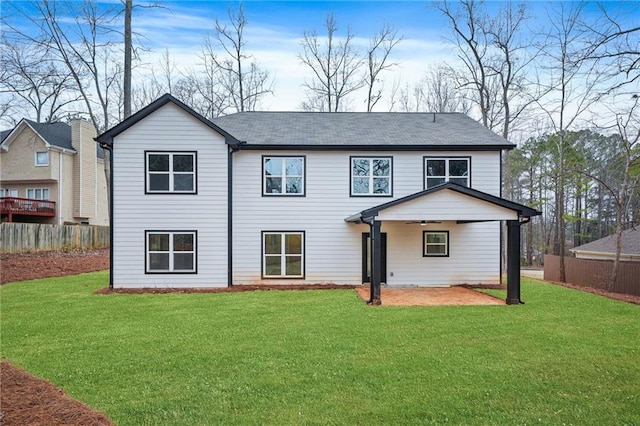 rear view of property with a patio area, fence, and a yard