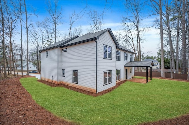 view of property exterior featuring a yard and fence