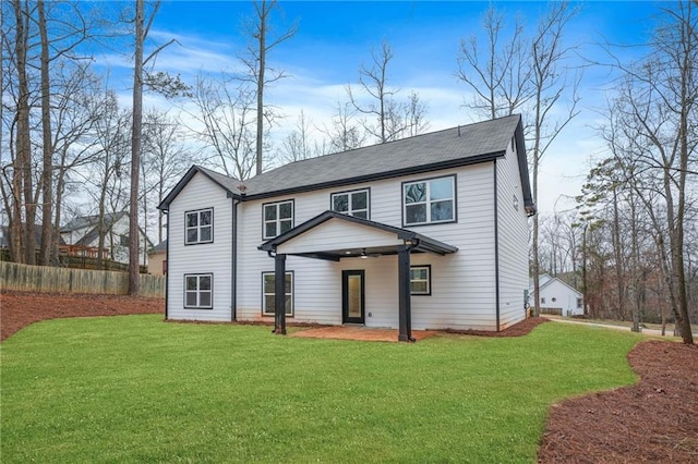 back of house with a yard, a patio, and fence