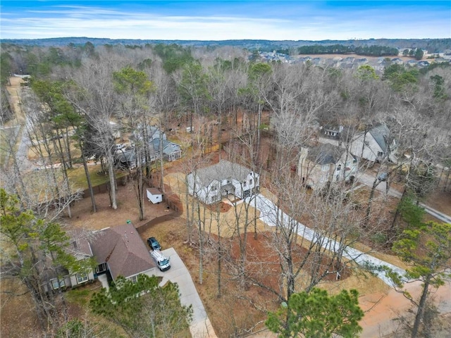 drone / aerial view featuring a wooded view