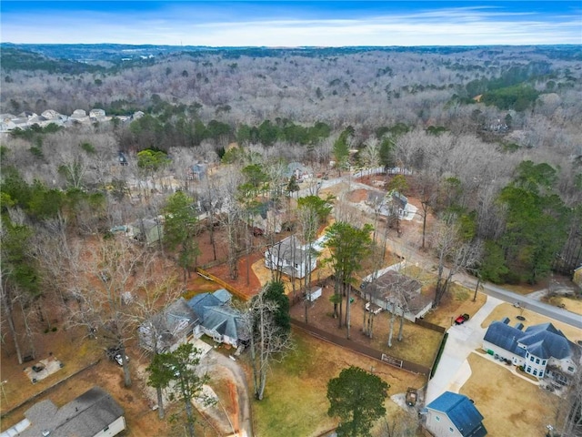 drone / aerial view featuring a wooded view