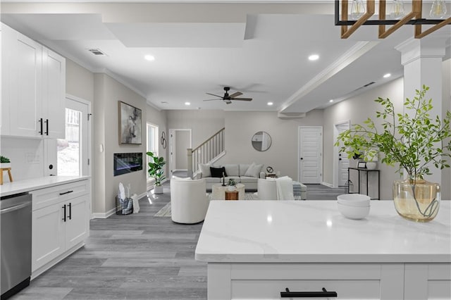 kitchen with visible vents, white cabinets, ornamental molding, stainless steel dishwasher, and recessed lighting