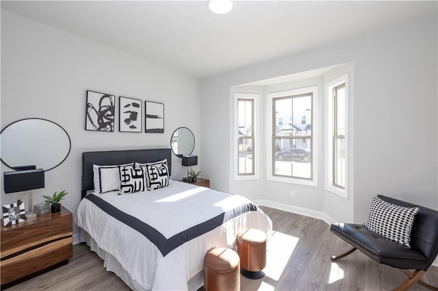 bedroom featuring wood finished floors and baseboards