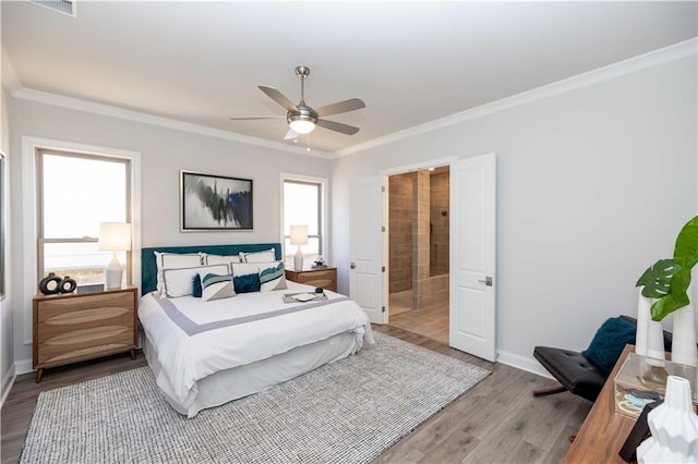 bedroom featuring ornamental molding, multiple windows, wood finished floors, and baseboards