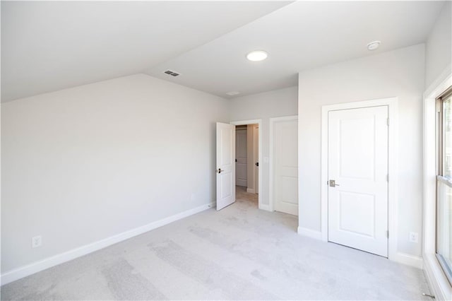 unfurnished bedroom with light colored carpet, visible vents, and baseboards