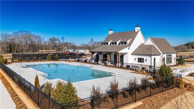 pool with fence and a patio