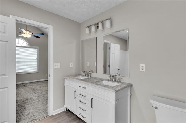 7185 Sweet Gum Ct, Lithonia, GA 30058 - bathroom featuring double vanity, a sink, toilet, and ceiling fan