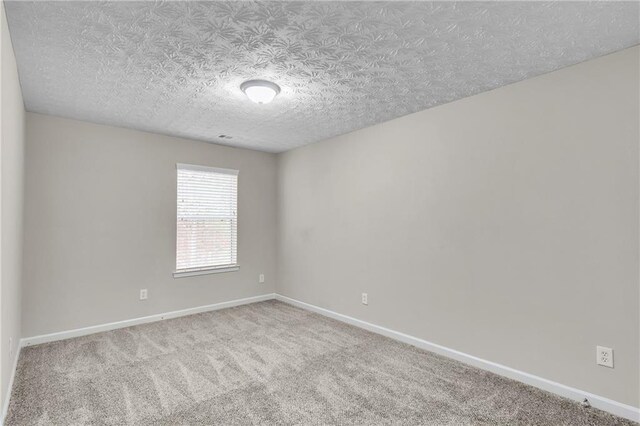 7185 Sweet Gum Ct, Lithonia, GA 30058 - carpeted spare room featuring baseboards and a textured ceiling