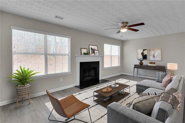 7185 Sweet Gum Ct, Lithonia, GA 30058 - living room featuring visible vents, ceiling fan, wood finished floors, and a textured ceiling