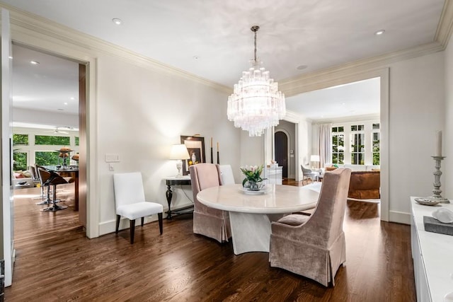 dining room featuring crown molding, plenty of natural light, a chandelier, and dark hardwood / wood-style floors