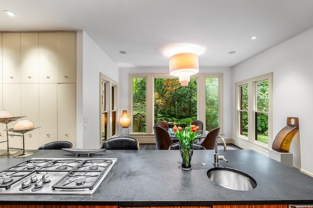 kitchen with stainless steel gas cooktop, sink, and a wealth of natural light