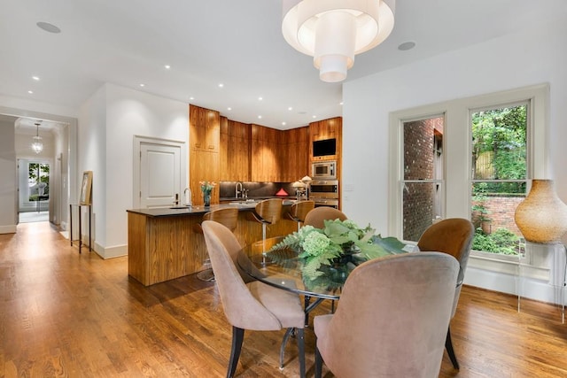 dining area featuring dark hardwood / wood-style floors, a healthy amount of sunlight, and sink