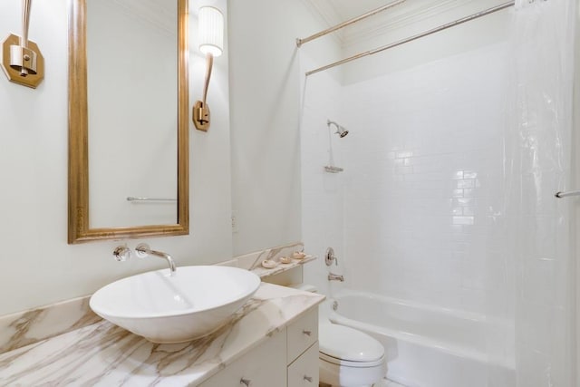 full bathroom with toilet, crown molding, tiled shower / bath, and vanity