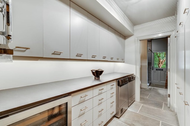 kitchen with white cabinets, dishwasher, black dishwasher, and wine cooler