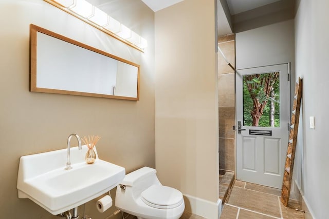 bathroom with tile patterned flooring, toilet, and sink