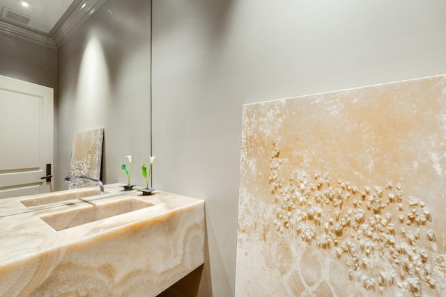 bathroom featuring sink and ornamental molding