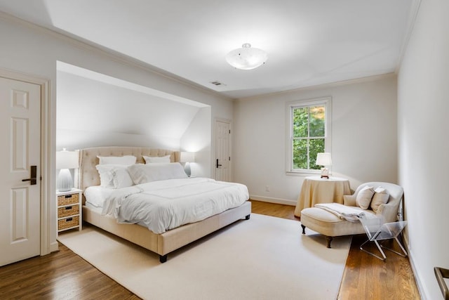 bedroom featuring crown molding and hardwood / wood-style floors