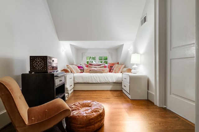 bedroom with light hardwood / wood-style flooring and vaulted ceiling