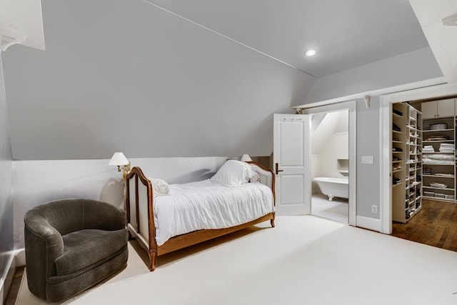 bedroom featuring dark wood-type flooring and lofted ceiling