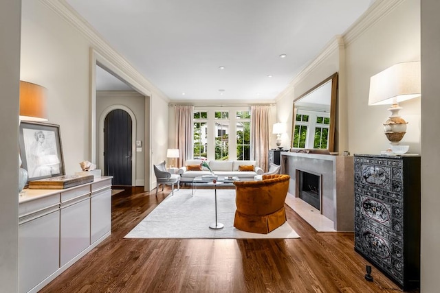 living room with dark hardwood / wood-style flooring and crown molding