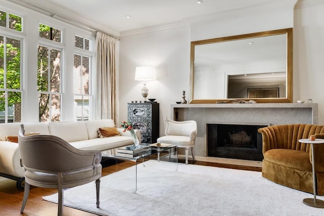 sitting room featuring wood-type flooring and crown molding