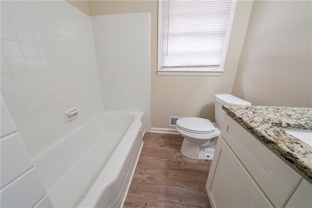 2104 Barbara Ln, Decatur, GA 30032 - full bathroom with tiled shower / bath, vanity, toilet, and wood-type flooring