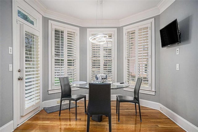 dining room featuring a chandelier, wood finished floors, and a healthy amount of sunlight