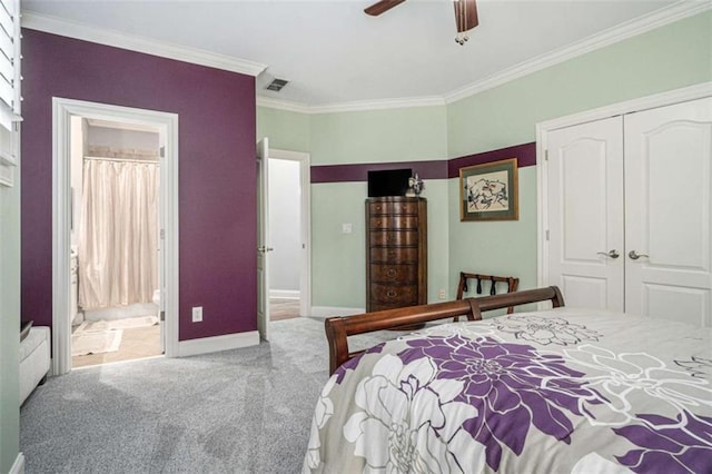 carpeted bedroom featuring a closet, visible vents, ensuite bathroom, ornamental molding, and baseboards