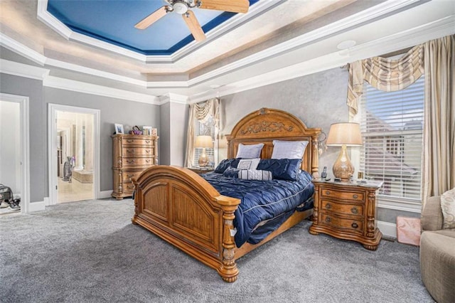 bedroom with a raised ceiling, ornamental molding, carpet flooring, and baseboards