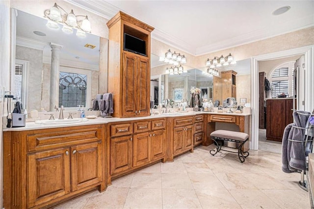 full bathroom with double vanity, ornamental molding, a sink, and ornate columns