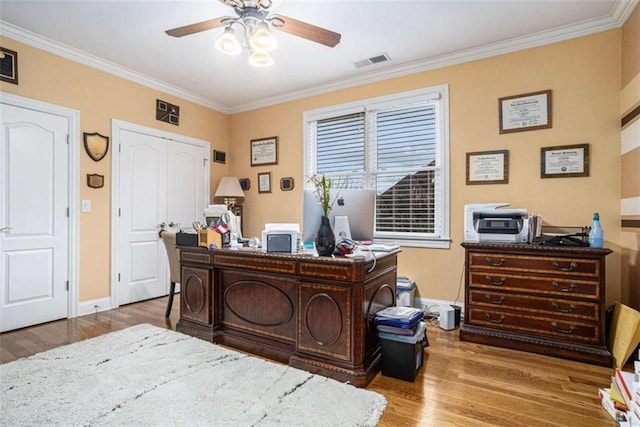 office space with a ceiling fan, visible vents, crown molding, and wood finished floors