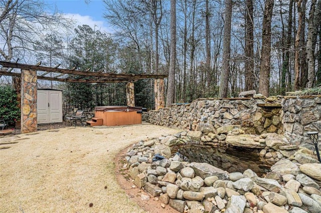 view of yard with an outdoor structure, a hot tub, and a storage shed