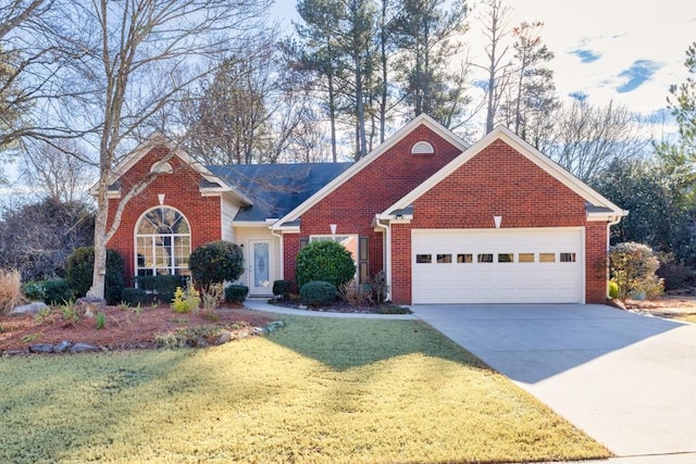 view of front of property featuring a garage and a front lawn