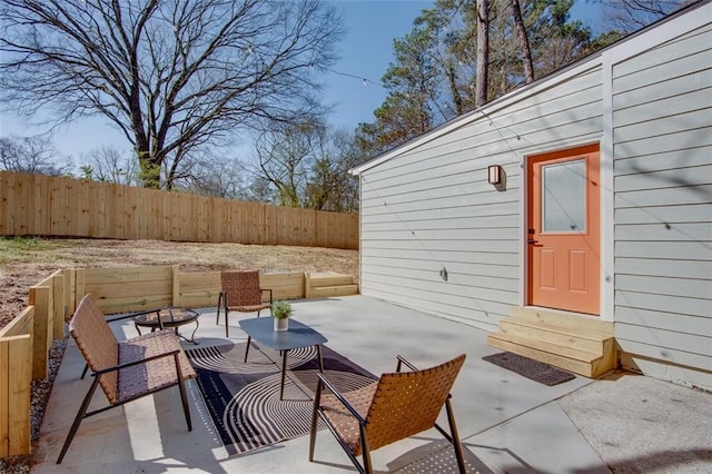 view of patio / terrace with entry steps and fence