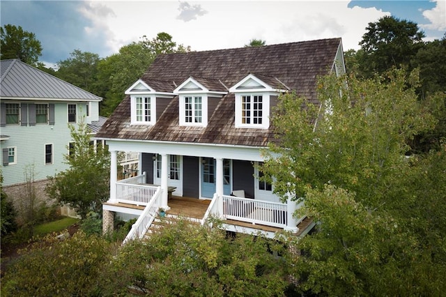 rear view of house with stairs and a porch