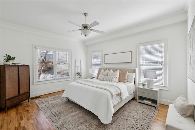 bedroom with ornamental molding, hardwood / wood-style floors, and ceiling fan