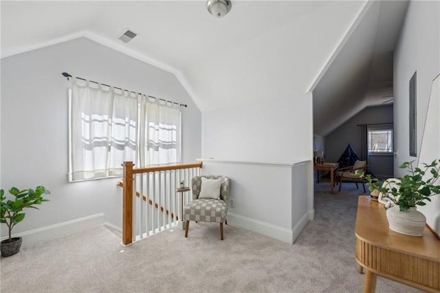 sitting room featuring vaulted ceiling and light colored carpet