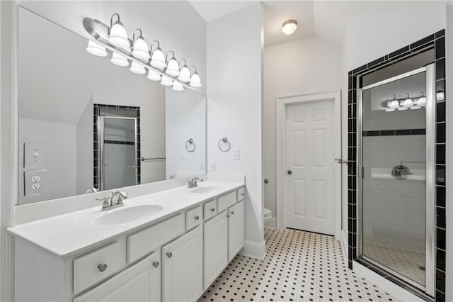 bathroom featuring lofted ceiling, an enclosed shower, vanity, and toilet