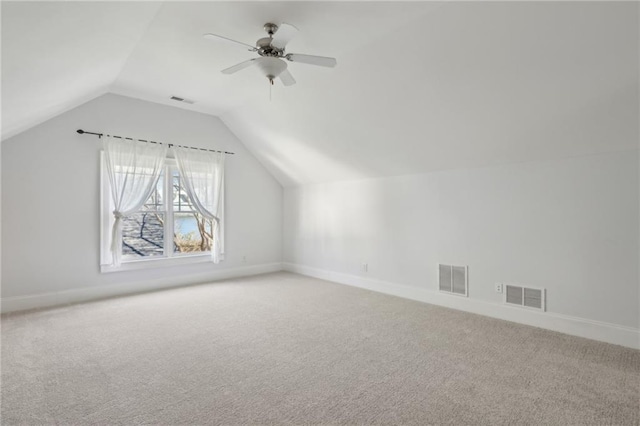 additional living space with lofted ceiling, carpet flooring, and ceiling fan