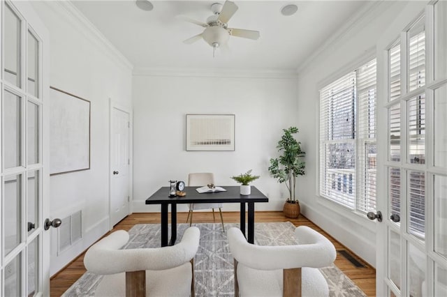 office space with crown molding, ceiling fan, wood-type flooring, and french doors