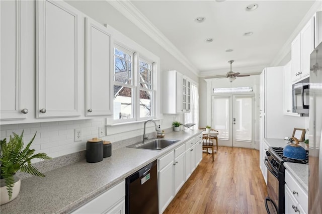 kitchen featuring sink, crown molding, white cabinetry, black appliances, and french doors