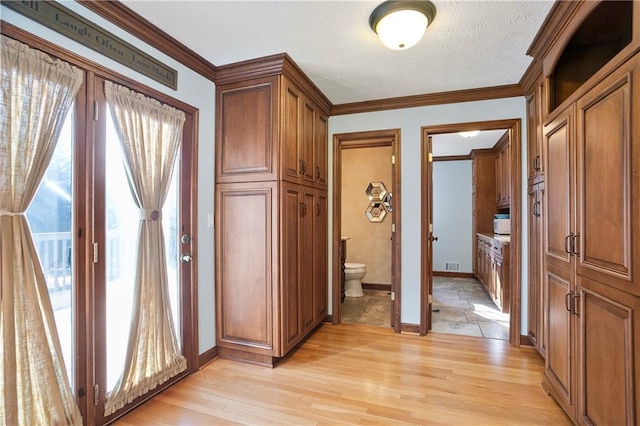 corridor featuring plenty of natural light and ornamental molding