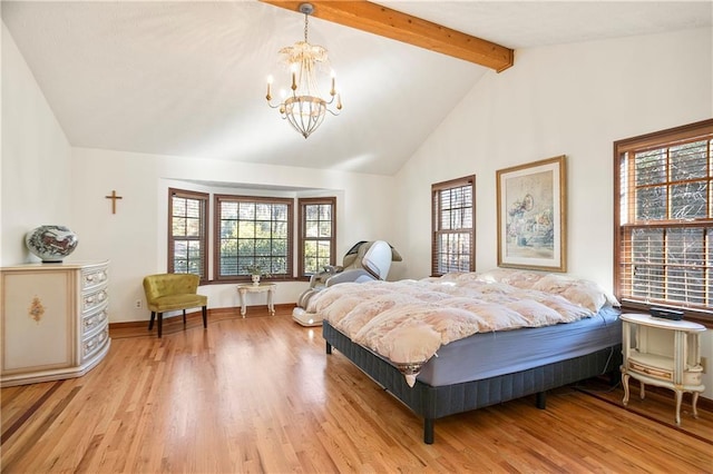 bedroom featuring a chandelier, multiple windows, light wood-type flooring, and beam ceiling