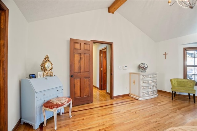 sitting room with baseboards, high vaulted ceiling, beamed ceiling, and light wood-style floors